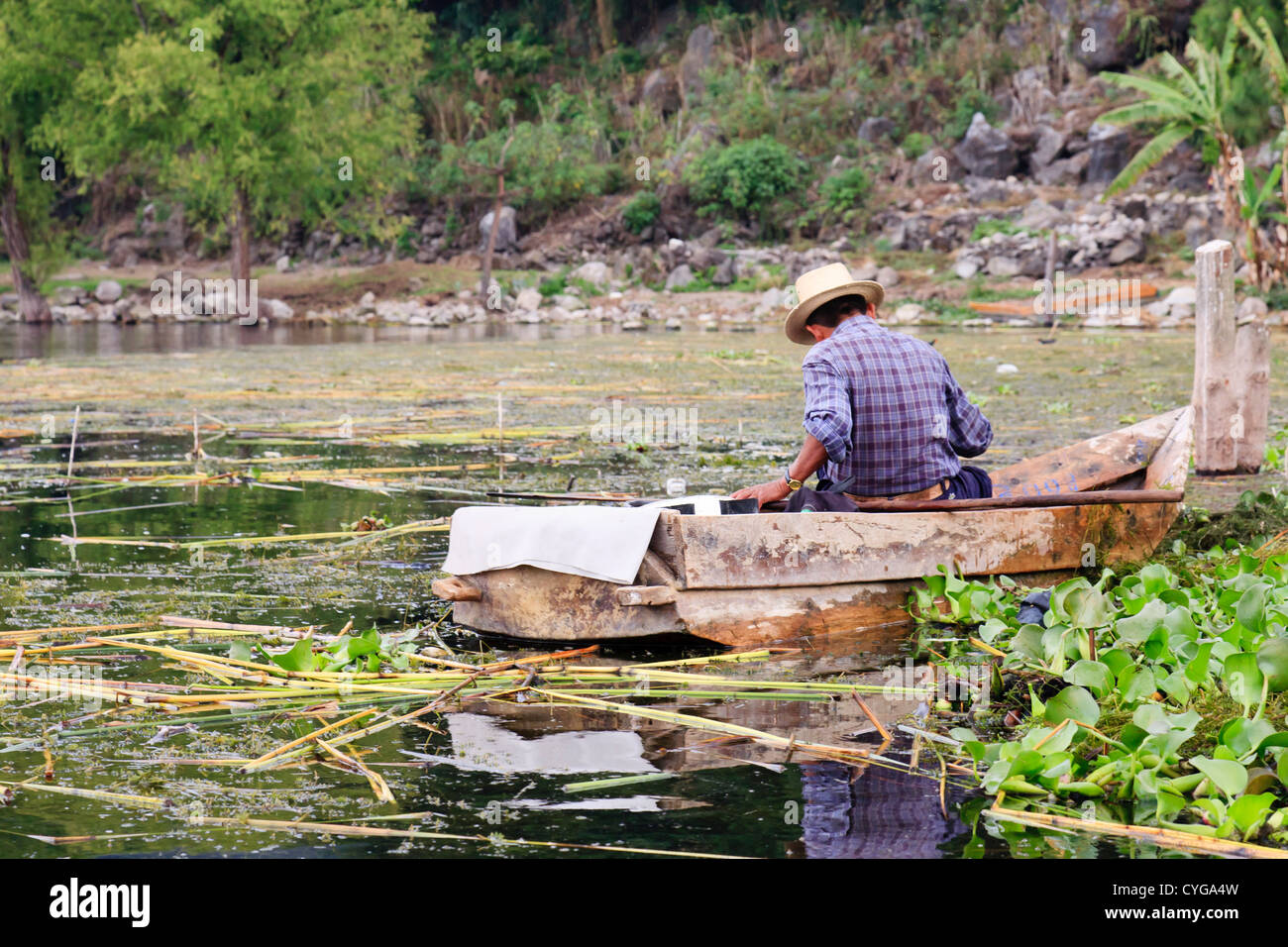 An old fisherman in Lake Atitlan, Guatemala. This lake, in the Guatemalan Highlands, is the deepest in Central America. Stock Photo