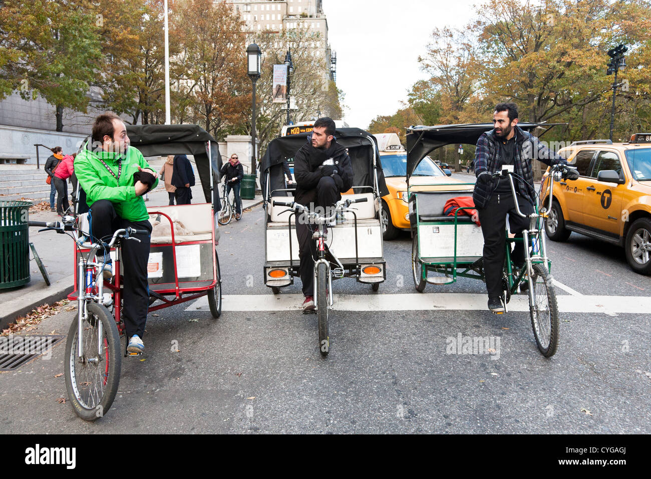 cheeky pedicab drivers, driving 3 abreast on central Park West, obstruct path of taxis & bus traffic Manhattan Stock Photo