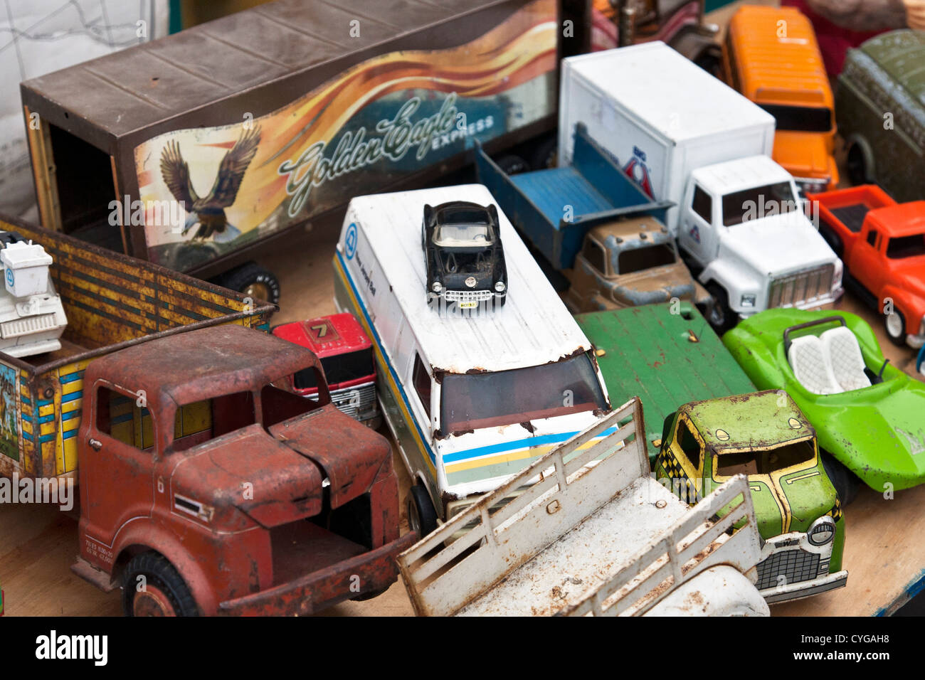 pileup of charming rusting vintage toy trucks & cars displayed for sale at 39th street weekend flea market Hells Kitchen Stock Photo