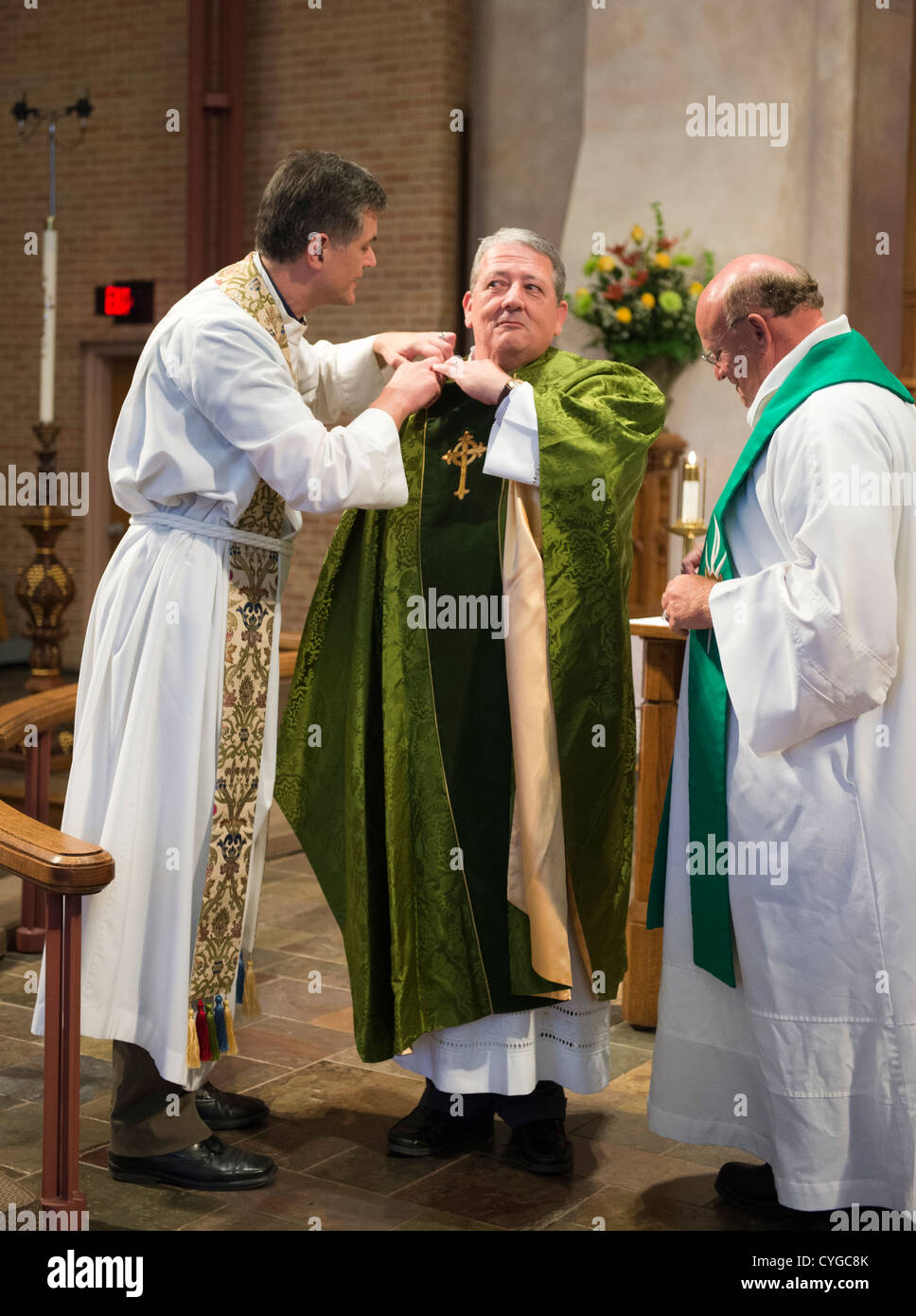 Pastors in albs and stoles beside Rev. Peder Sandager during his installation as senior pastor at St. Martin's Lutheran Church Stock Photo