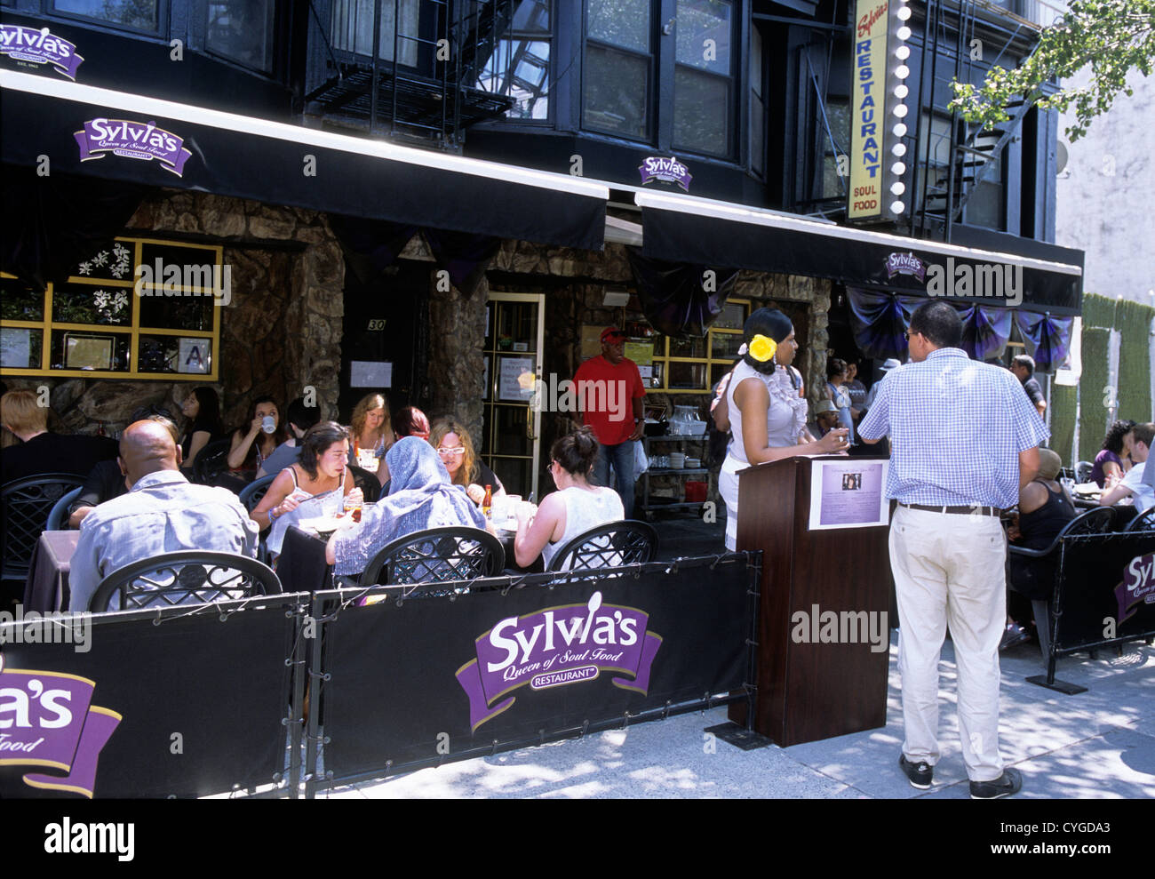 Harlem, New York City, Multi ethnic neighborhood, multiethnic. Sylvia's Restaurant famous outdoor street dining. Tourist attraction, USA Stock Photo