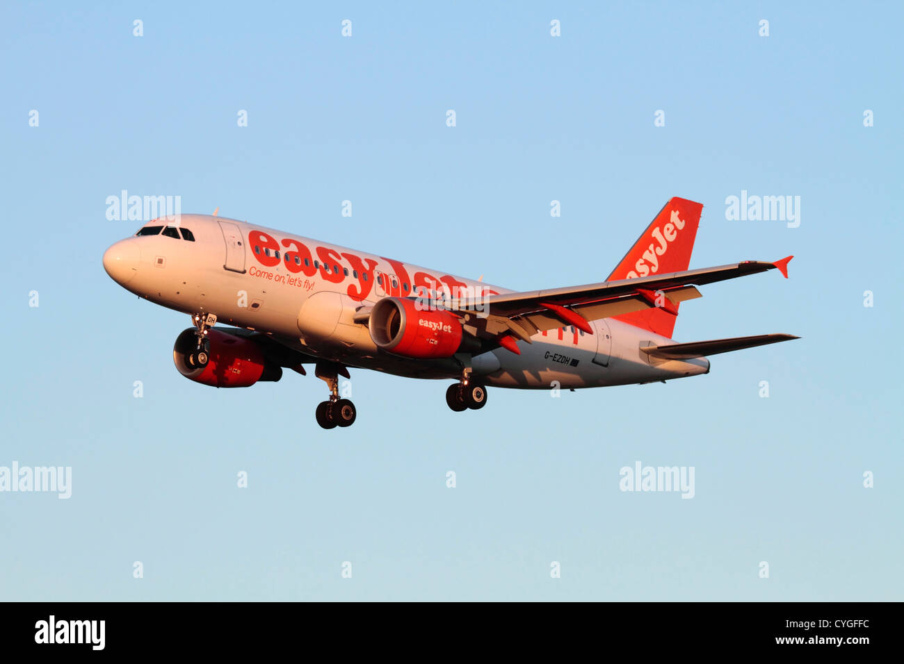 Cheap flights. Airbus A319 passenger jet belonging to low cost airline easyJet on approach at sunset Stock Photo