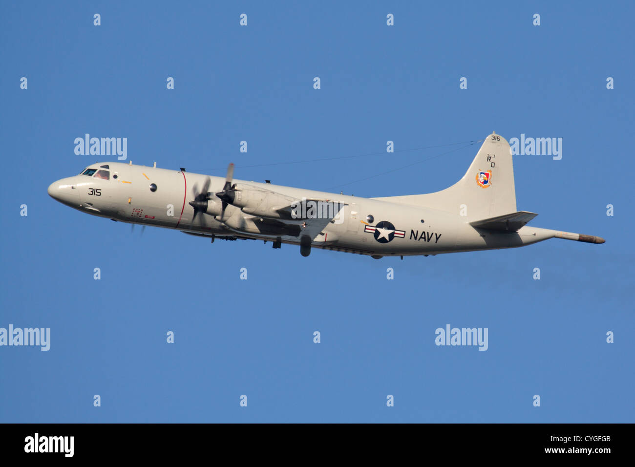 United States Navy Lockheed P-3C Orion turboprop maritime patrol plane flying against a clear blue sky Stock Photo
