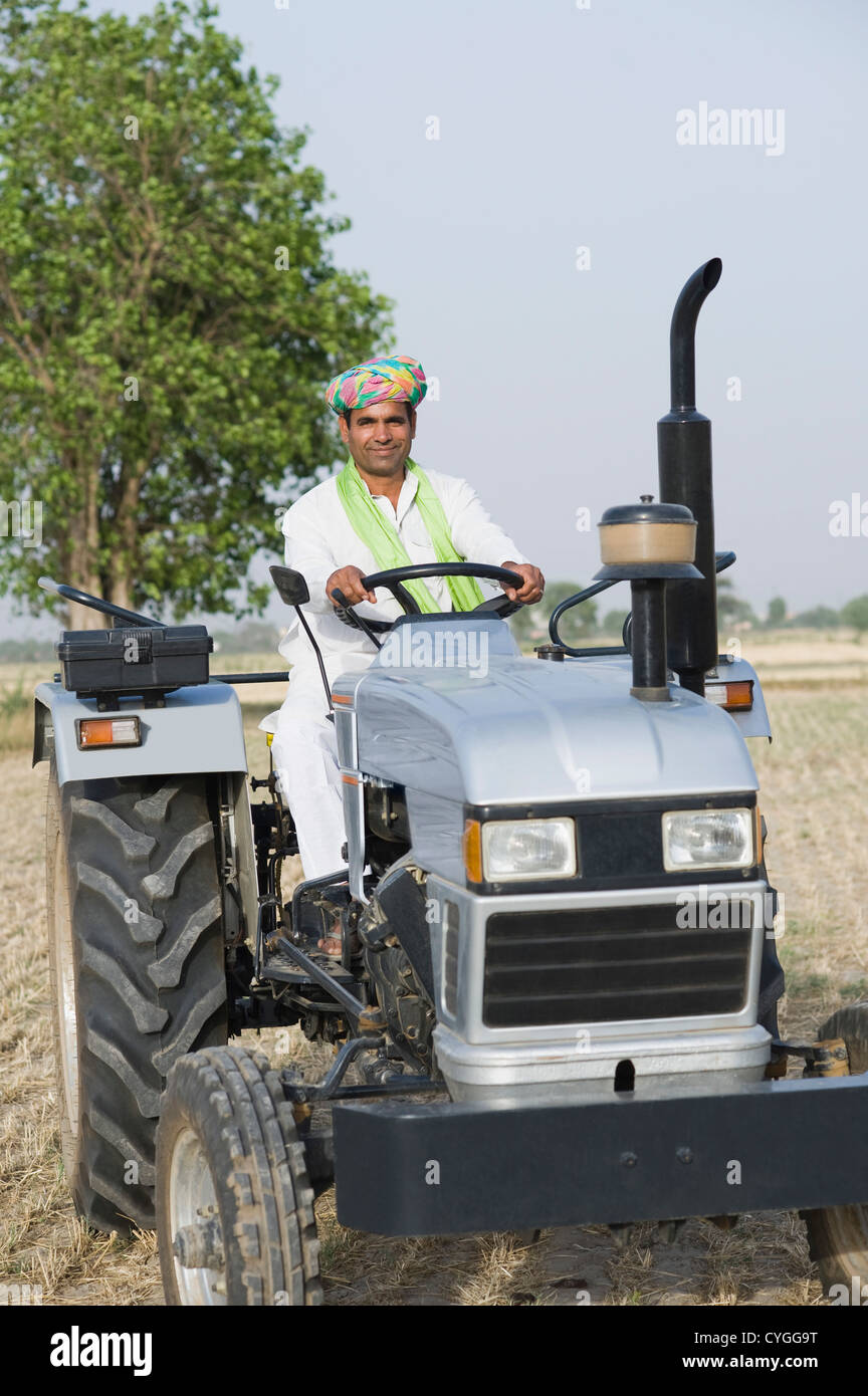 Indian farmer ploughing field tractor hi-res stock photography and ...