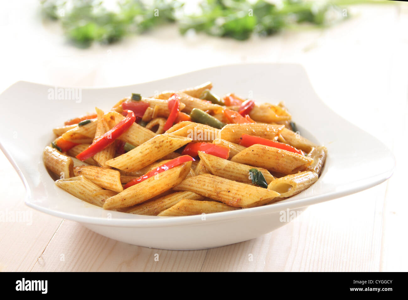Penne pasta cooked with spicy pepper sauce with vegables Stock Photo