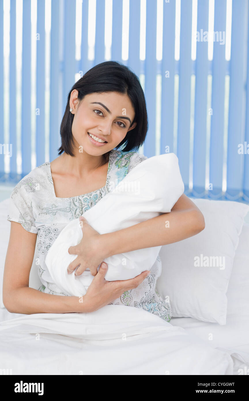 Woman carrying her newborn baby in a hospital Stock Photo - Alamy