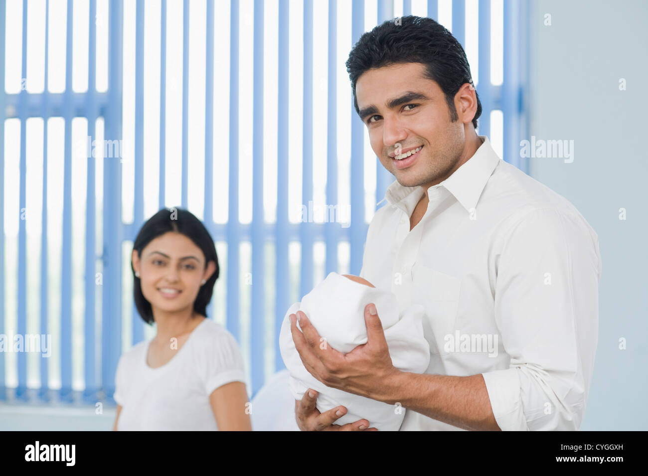 Man carrying his newborn baby in a hospital Stock Photo Alamy