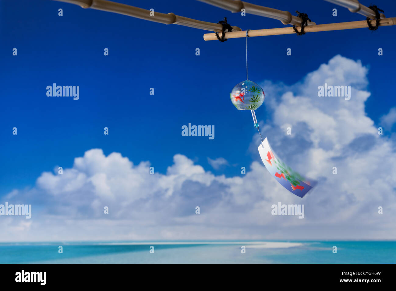 Wind chime and blue sky with clouds in the background Stock Photo