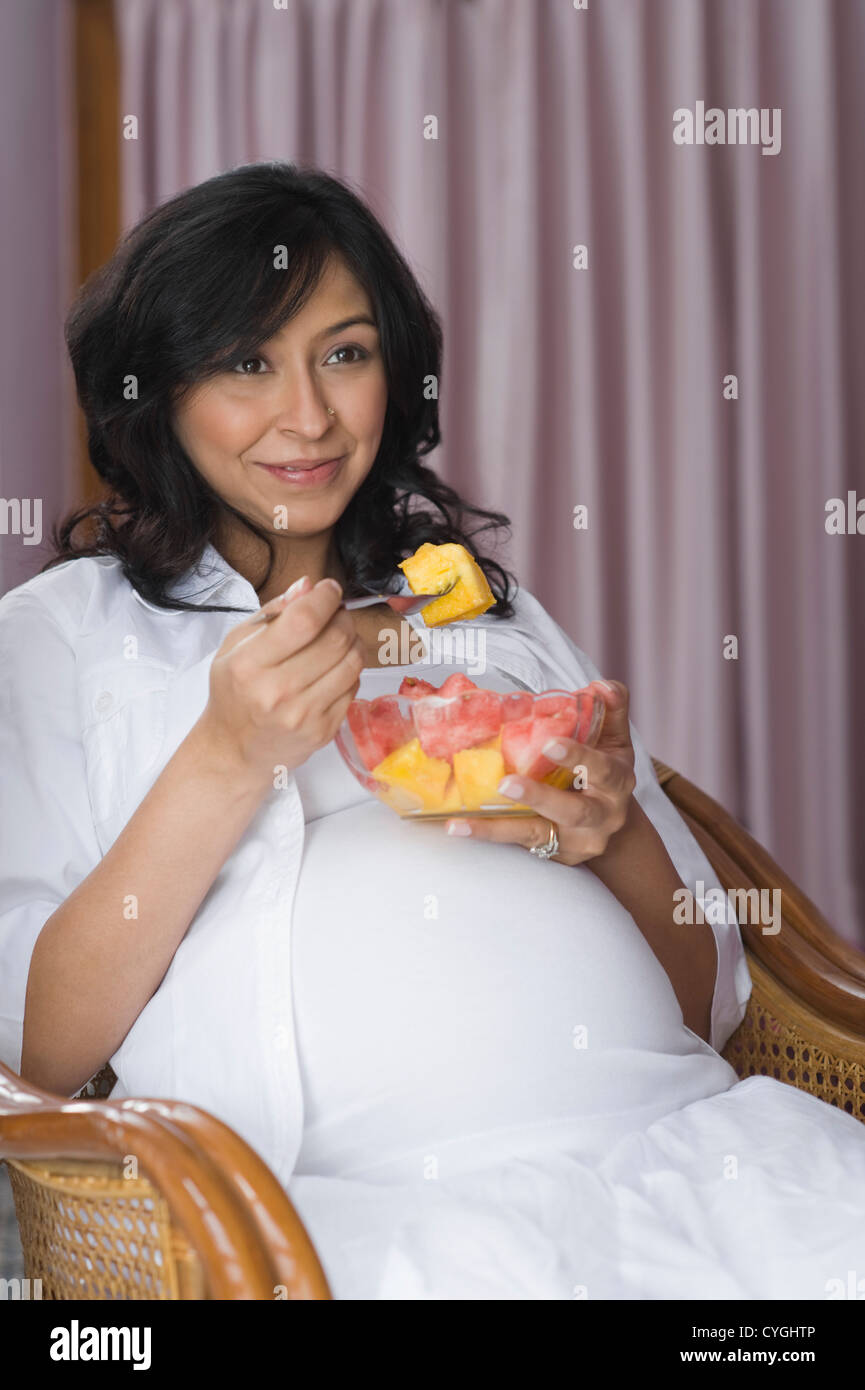 Pregnant woman eating fruit salad Stock Photo Alamy