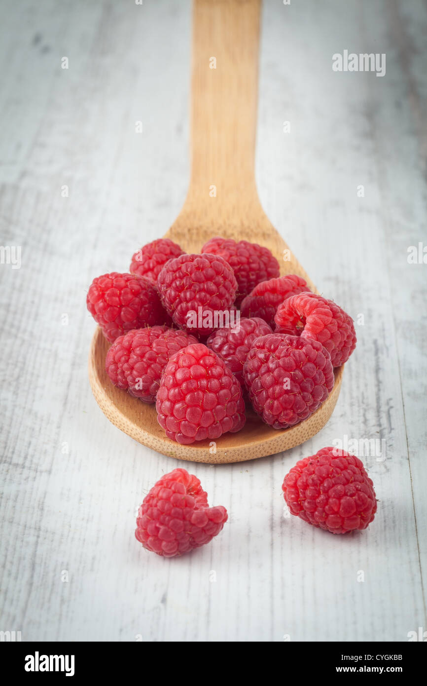Fresh juicy raspberry fruit on a wooden spoon Stock Photo
