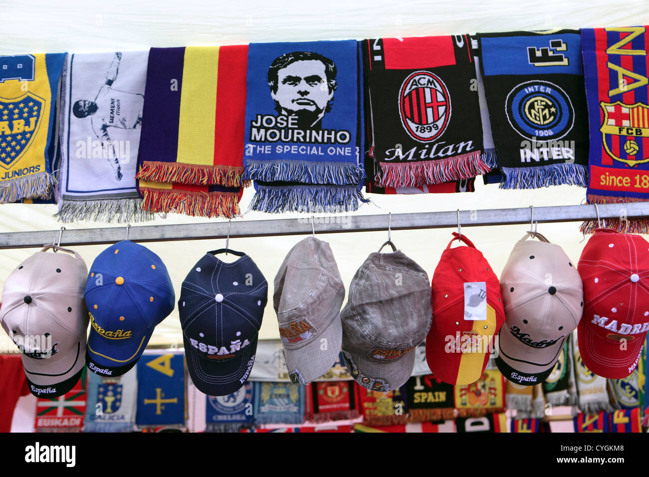 Street market, El Rastro, Madrid, Spain. Football souvenirs, scarves & baseball caps. Stock Photo