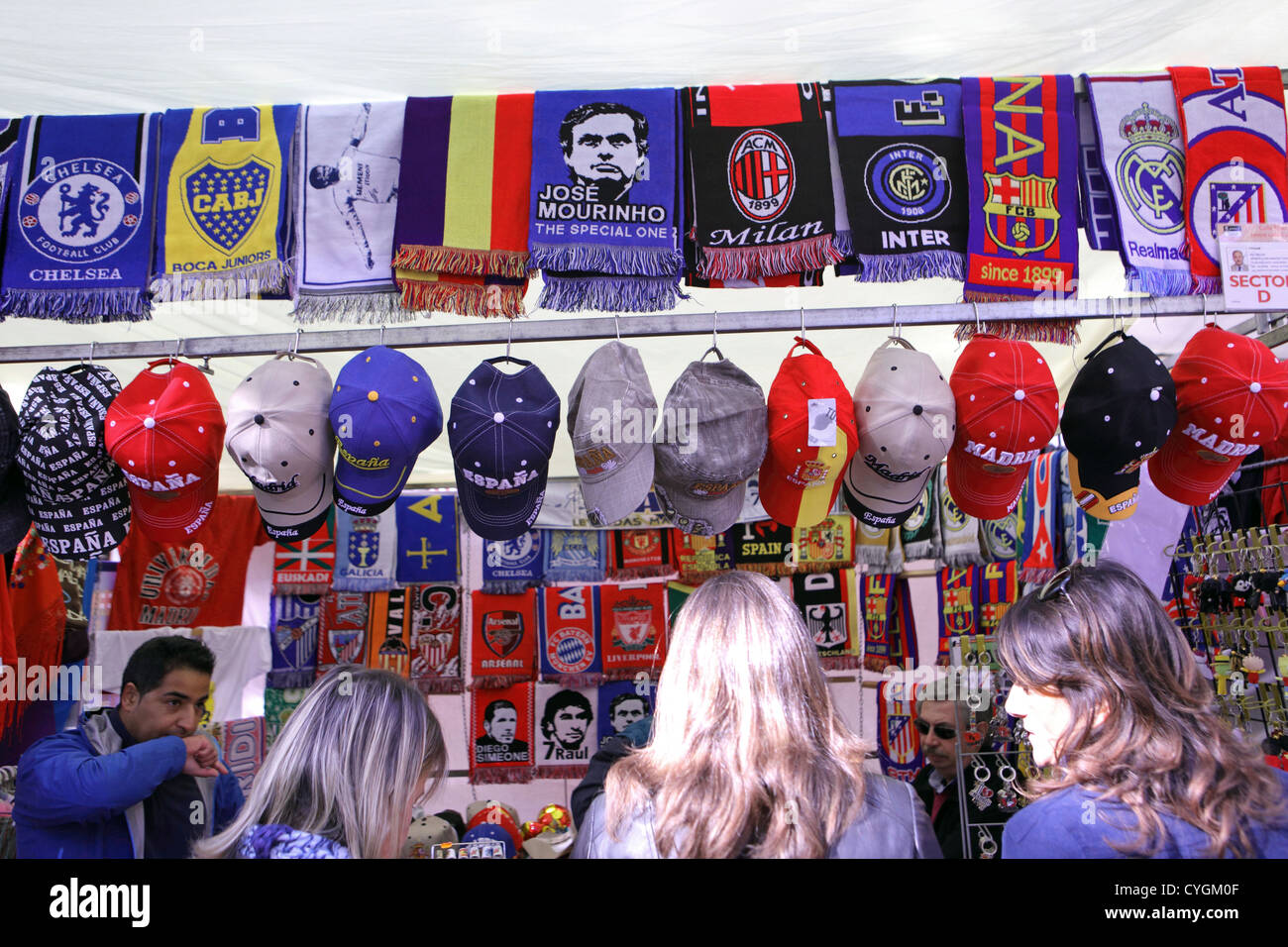 Street market, El Rastro, Madrid, Spain. Football souvenirs, scarves & baseball caps. Stock Photo