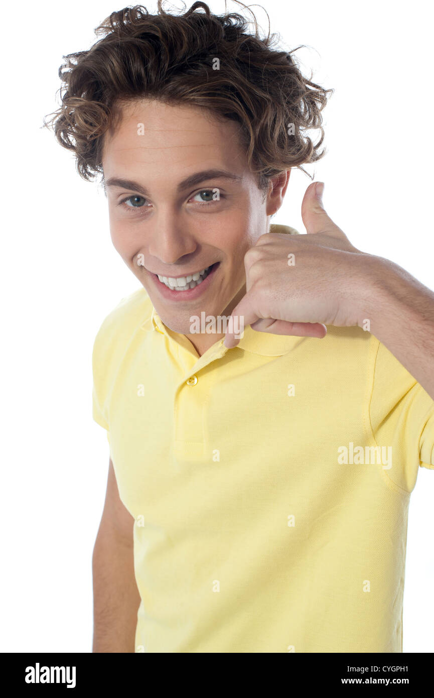 Handsome young guy gesturing call sign in front of camera Stock Photo