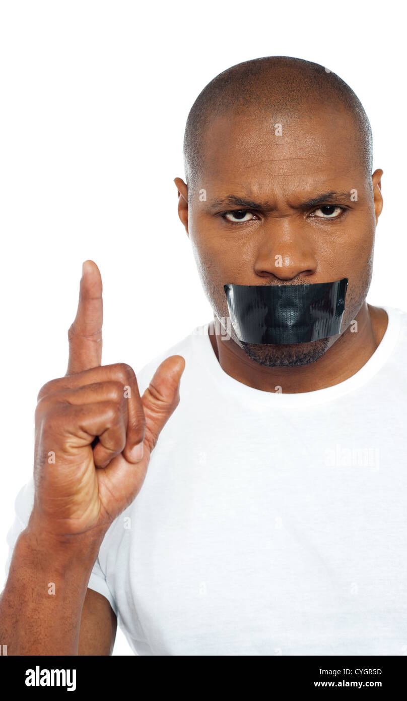 Tape on mouth of an african male model pointing upwards. Stock Photo