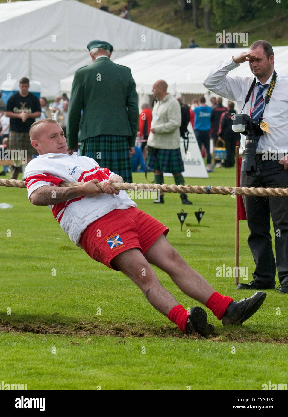 Team member taking part in a 'Tug of War' event at a Scottish Highland Games Stock Photo