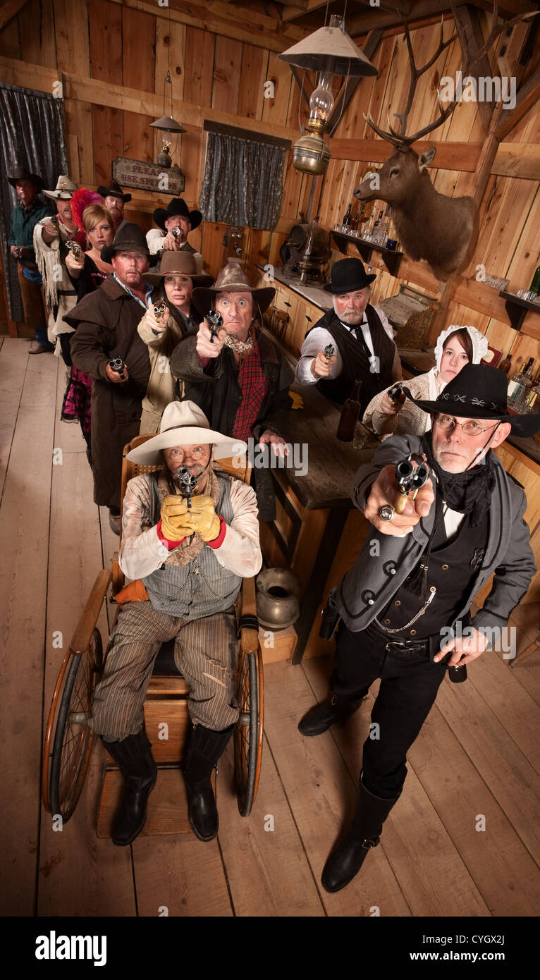 Serious people in old west saloon pull out their weapons Stock Photo - Alamy