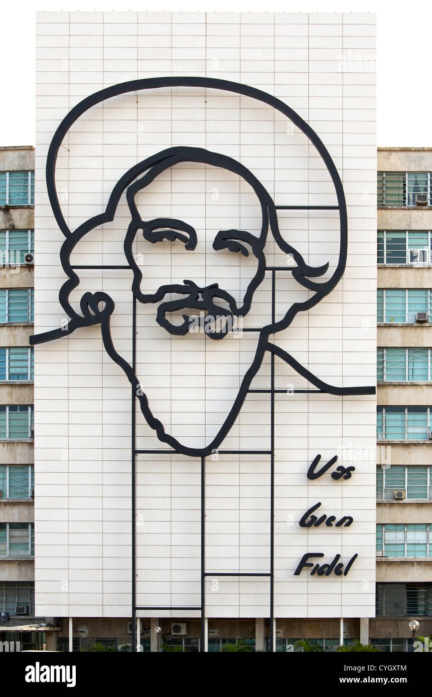Ministry of Informatics and Communications with image of Camilo Cienfuegos adorning the side of the building. Josi Marti Plaza Stock Photo