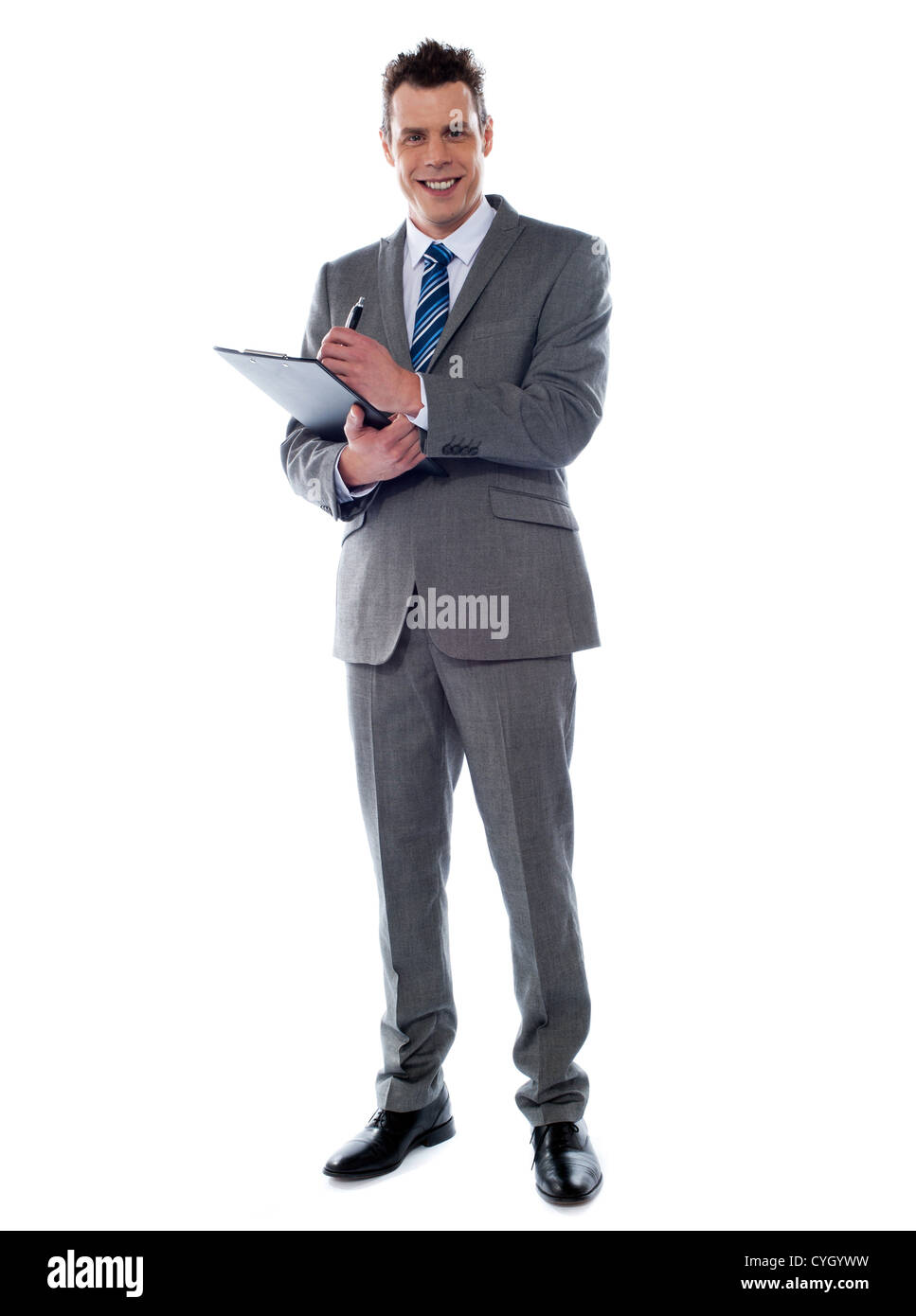 Smiling businessman writing on clipboard isolated over white Stock ...