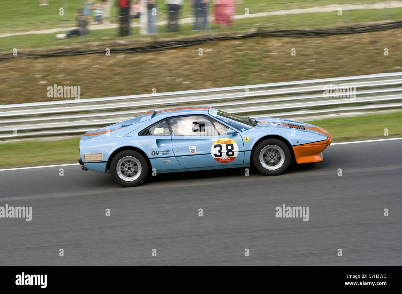 A Ferrari in blue and orange gulf colours racing at Brands Hatch circuit. Stock Photo