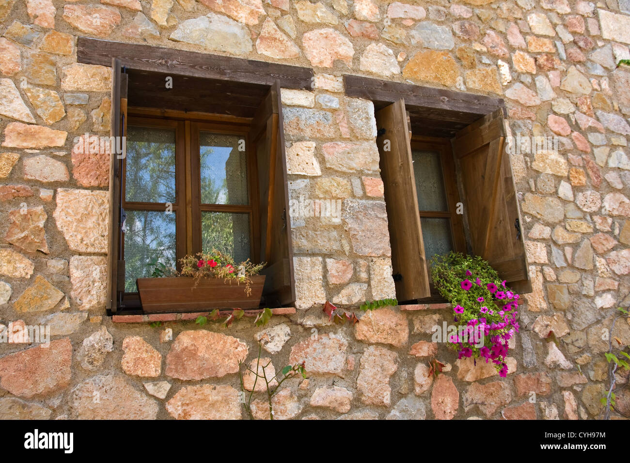 Wooden framed windows in stone wall, Siurana, Catalunya, Spain Stock Photo