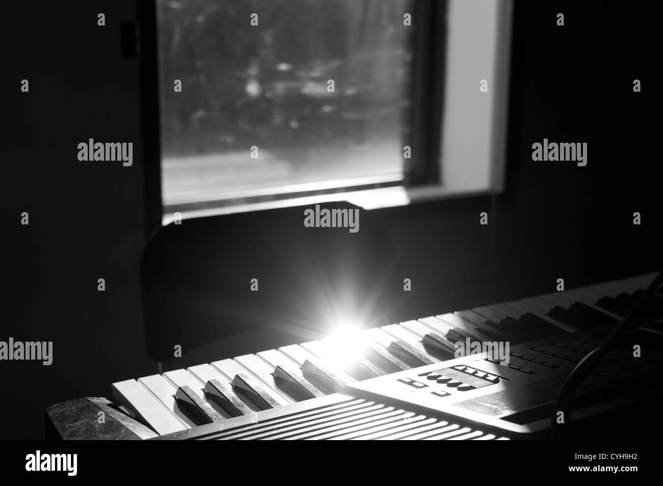 Sunray bouncing on electronic piano key Stock Photo