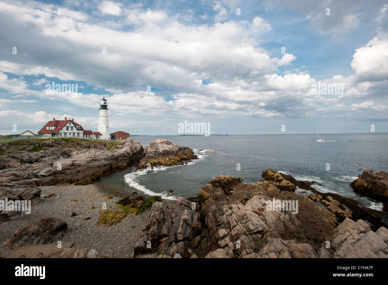Lighthouse overlooking rocky shore of Cape Elizabeth Maine Stock Photo