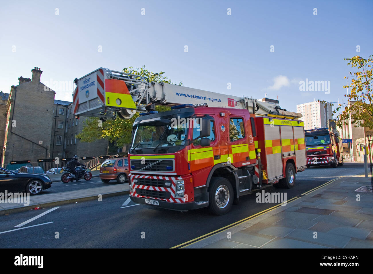 Fire Service elevating platform being followed by fire engine Stock