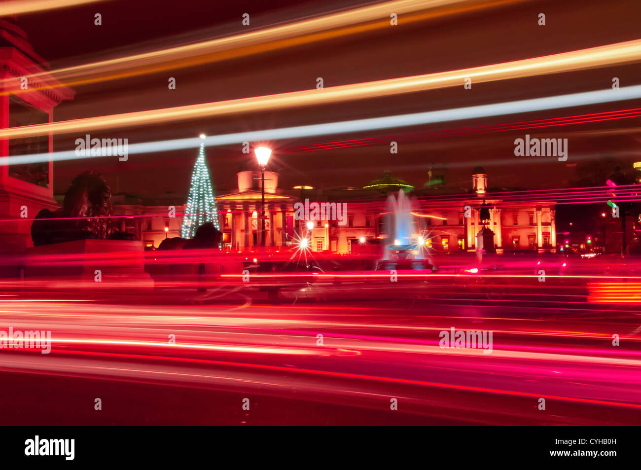 Trafalgar Square at night during Christmas with light trails in foreground London England Stock Photo