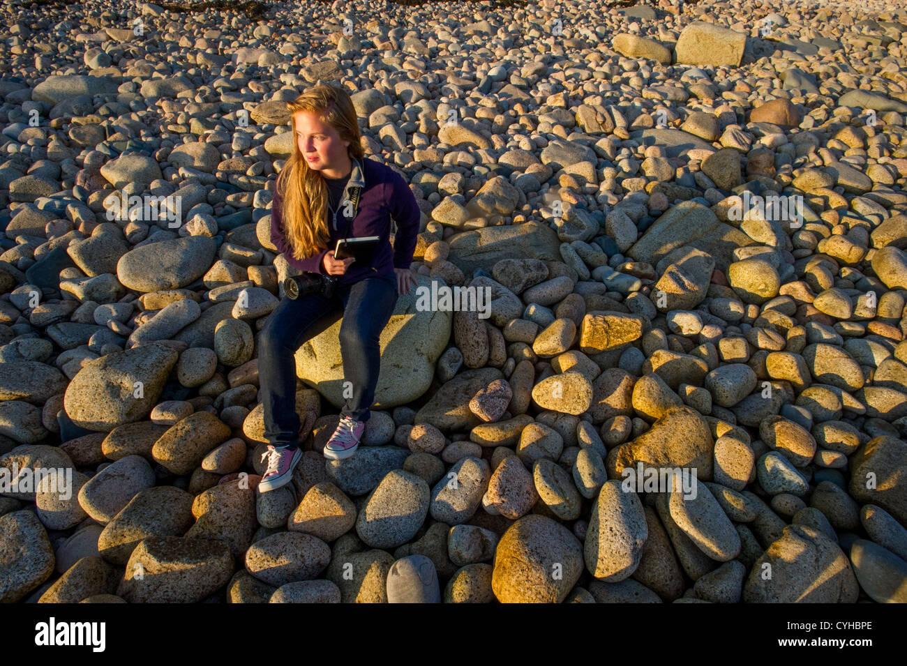 Woman on rocky coast of Acadia National Park Stock Photo