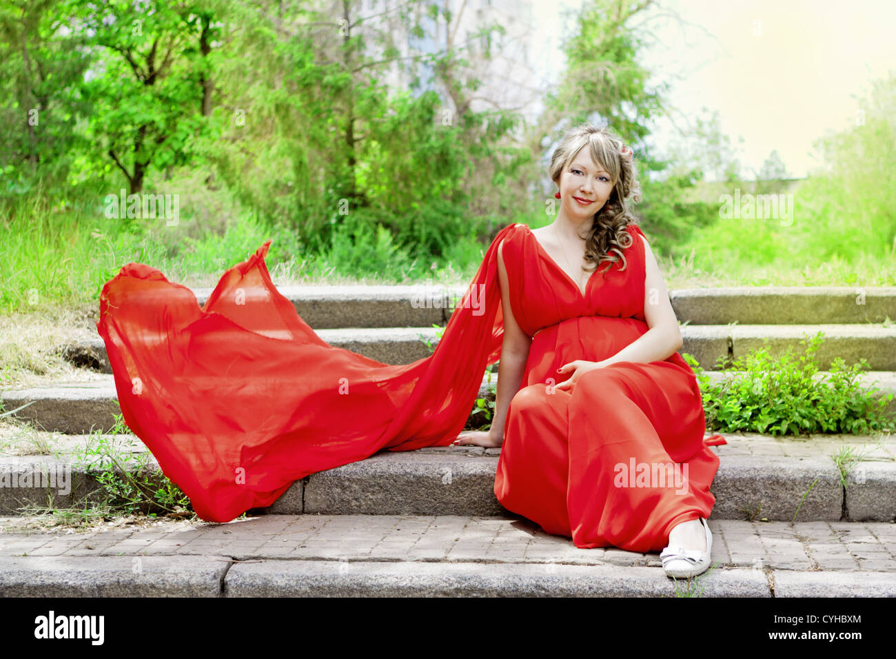 Woman red dress sitting hi-res stock photography and images - Alamy