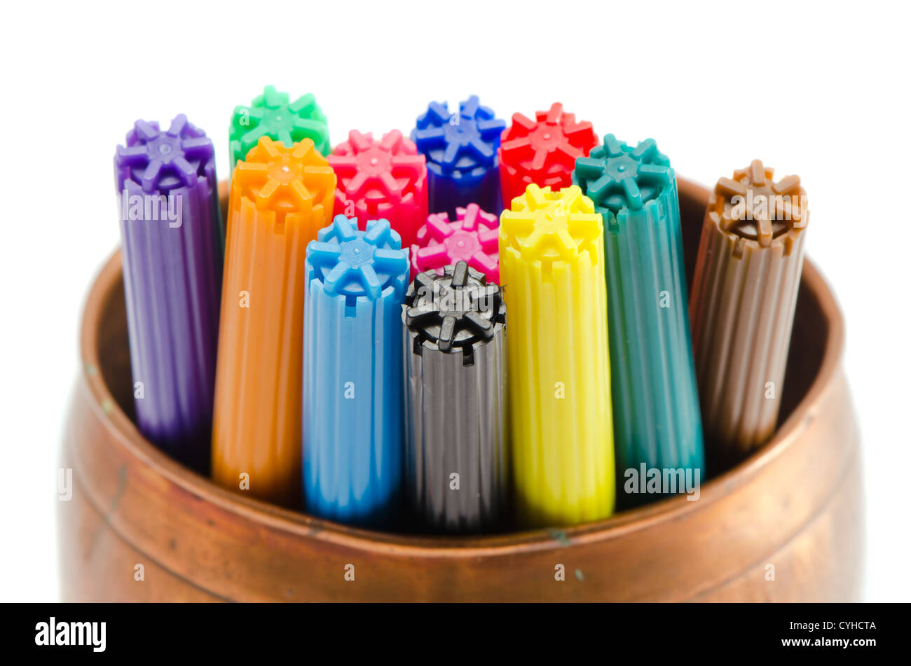 Closeup of motley colorful felt-tip pens in copper bowl isolated on white background. Stock Photo