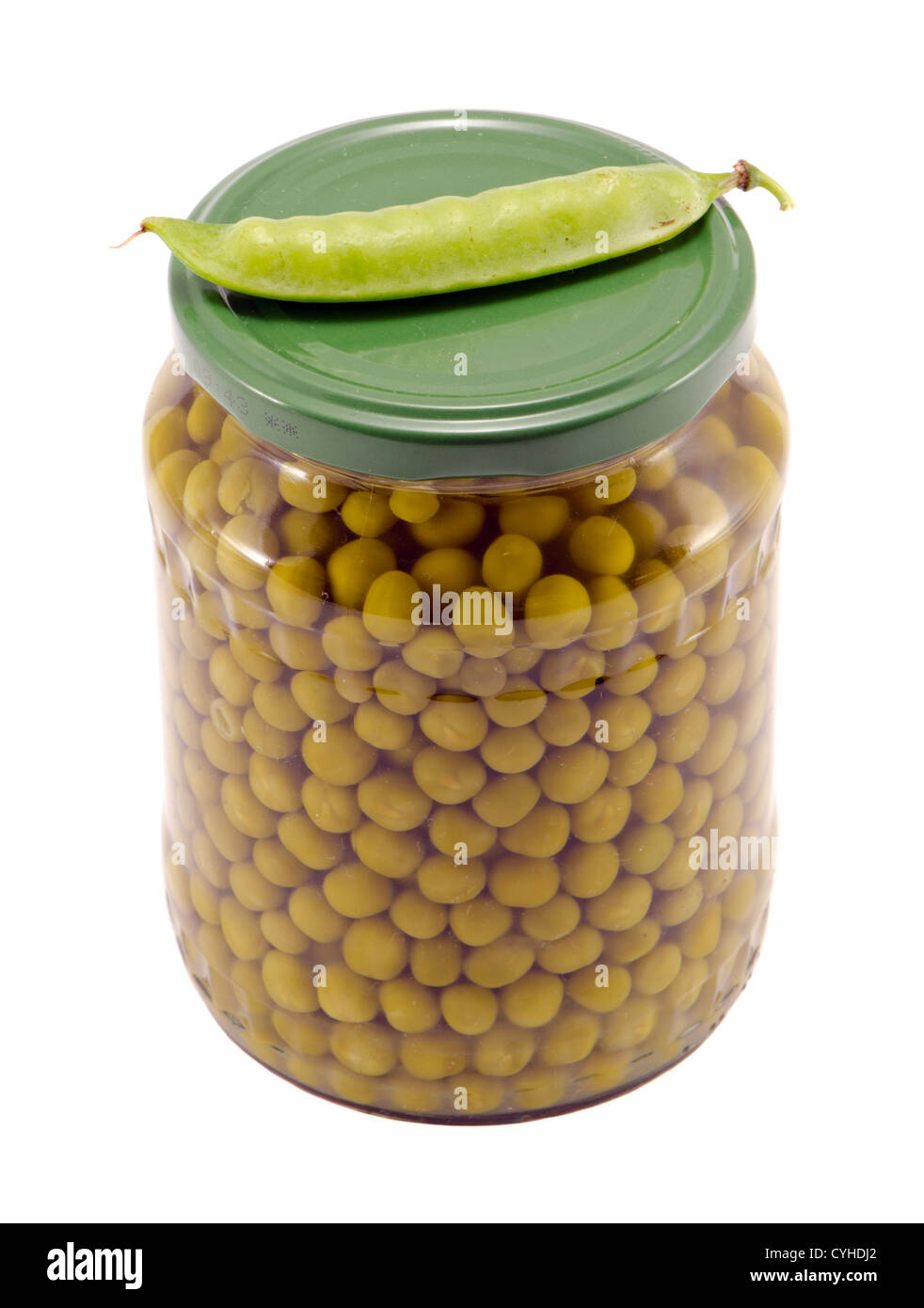 Pickled preserve pease in glass pot and fresh one on top. Food prepare for winter. Stock Photo
