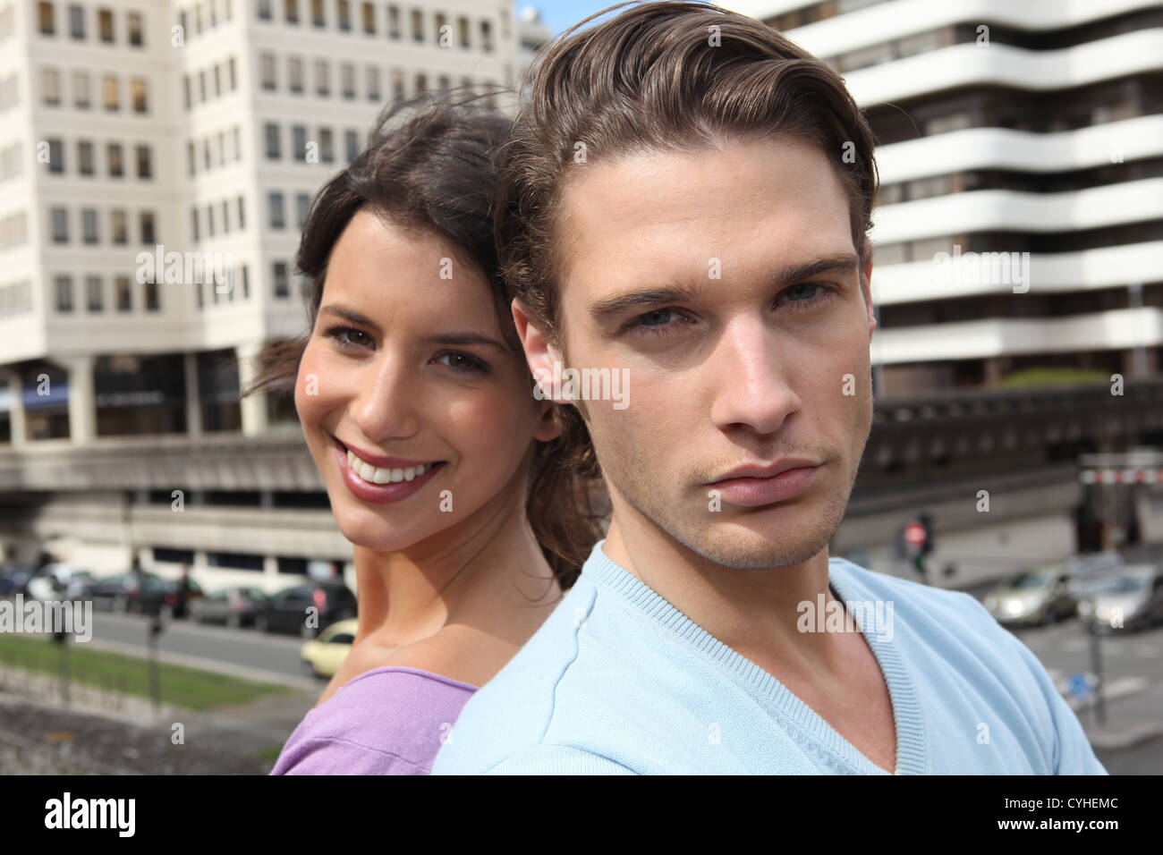 Couple stood outside of high-rise building Stock Photo - Alamy