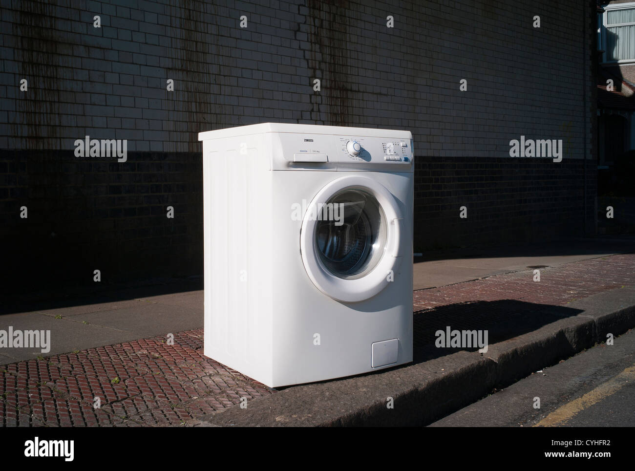 Fly tipping of white washing machine on pavement in Brent Cross Golders Green, London Stock Photo