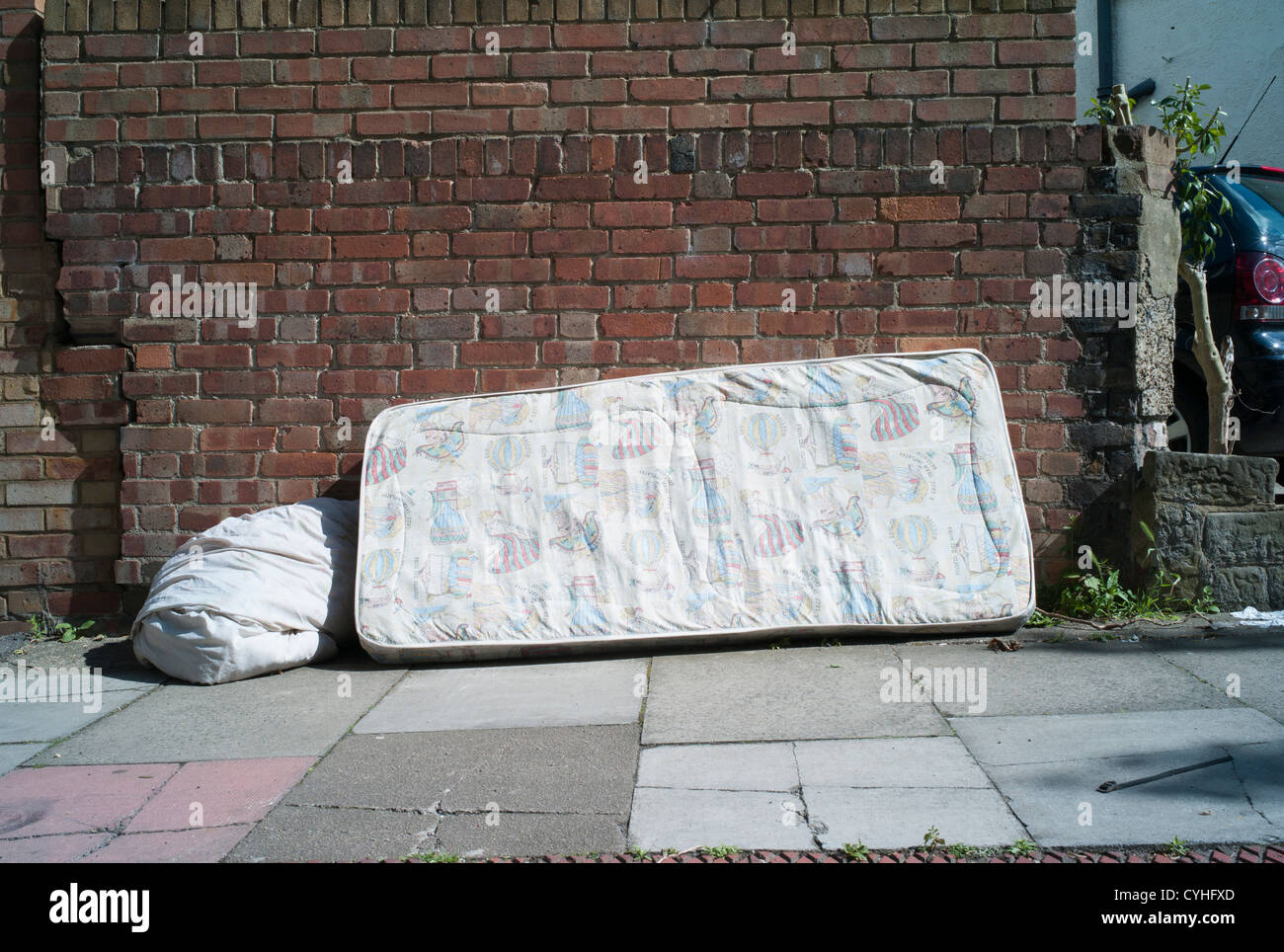 Fly tipping of old bedding and mattress dumped on pavement in Brent Cross Golders Green, London Stock Photo