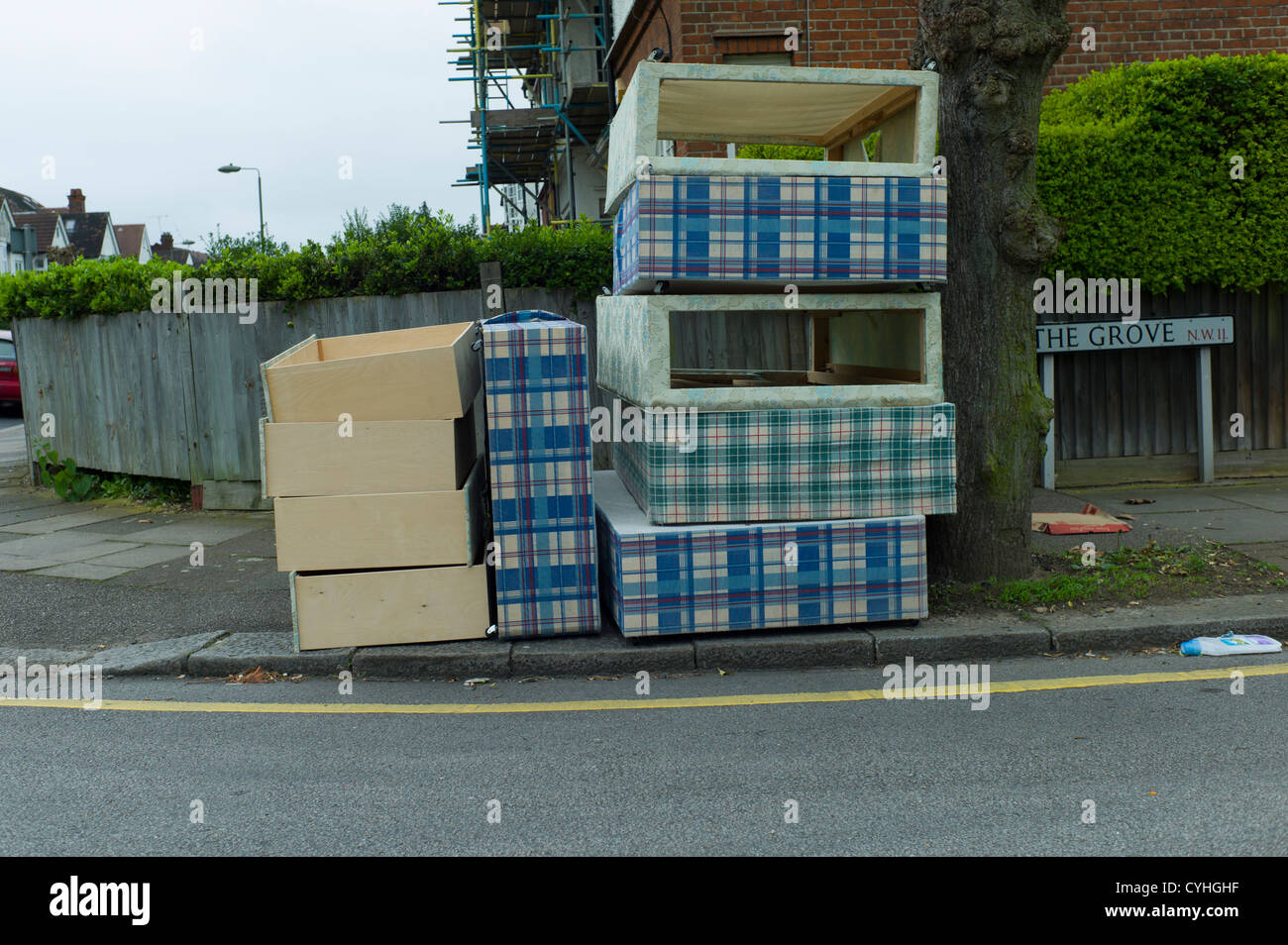 Fly tipping of old beds and mattresses on pavement in residential road in Brent Cross Golders Green, London Stock Photo