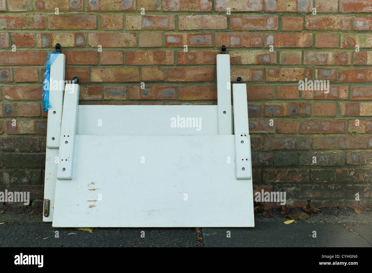 Fly tipping of wooded bed head board in Brent Cross Golders Green, London Stock Photo