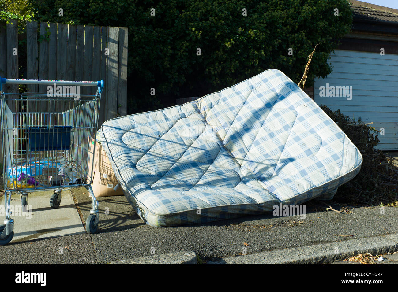 Fly tipping of old mattress and shopping trolling in Brent Cross Golders Green, London Stock Photo