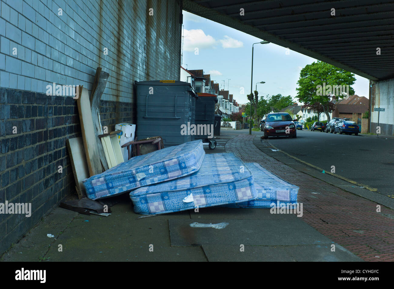 Fly tipping of rubbish and bed mattresses in residential road in Brent Cross Golders Green, London Stock Photo