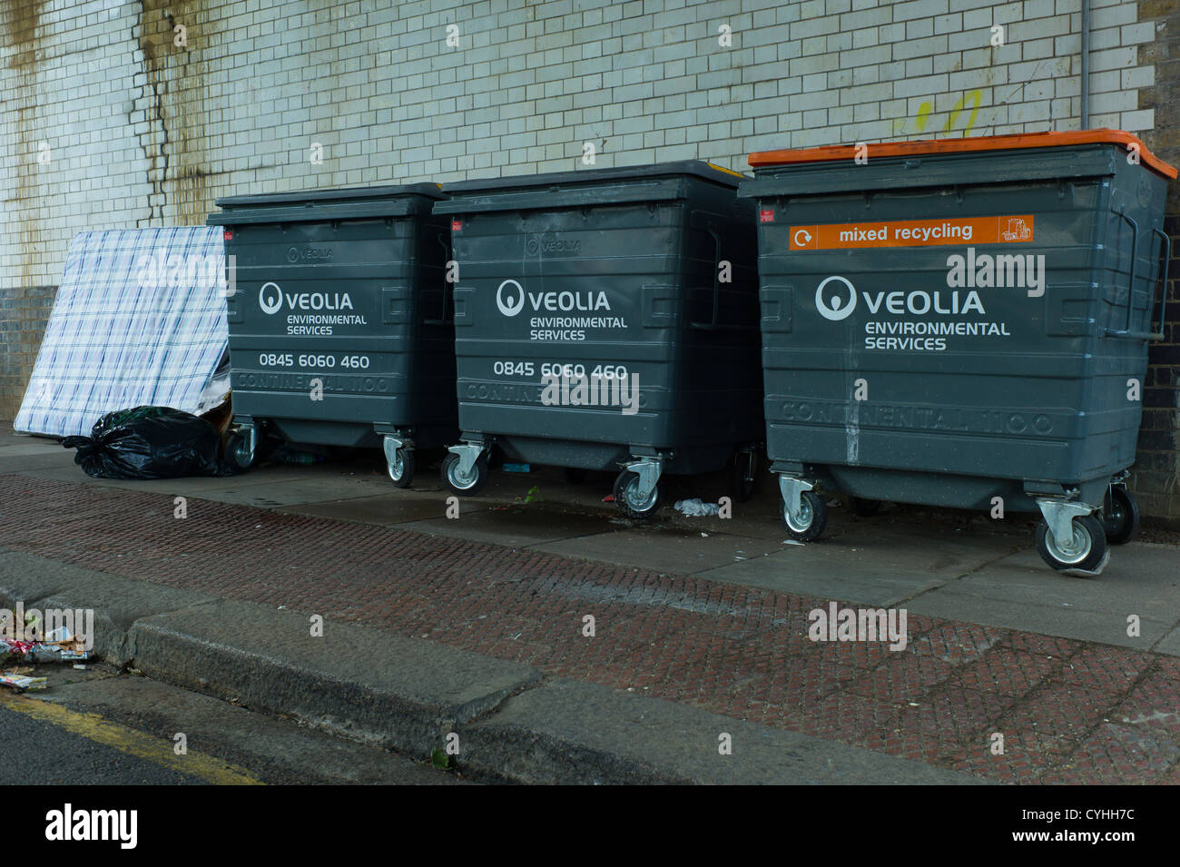 Fly tipping of rubbish, and large commercial wheelie bins in residential street, in Brent Cross