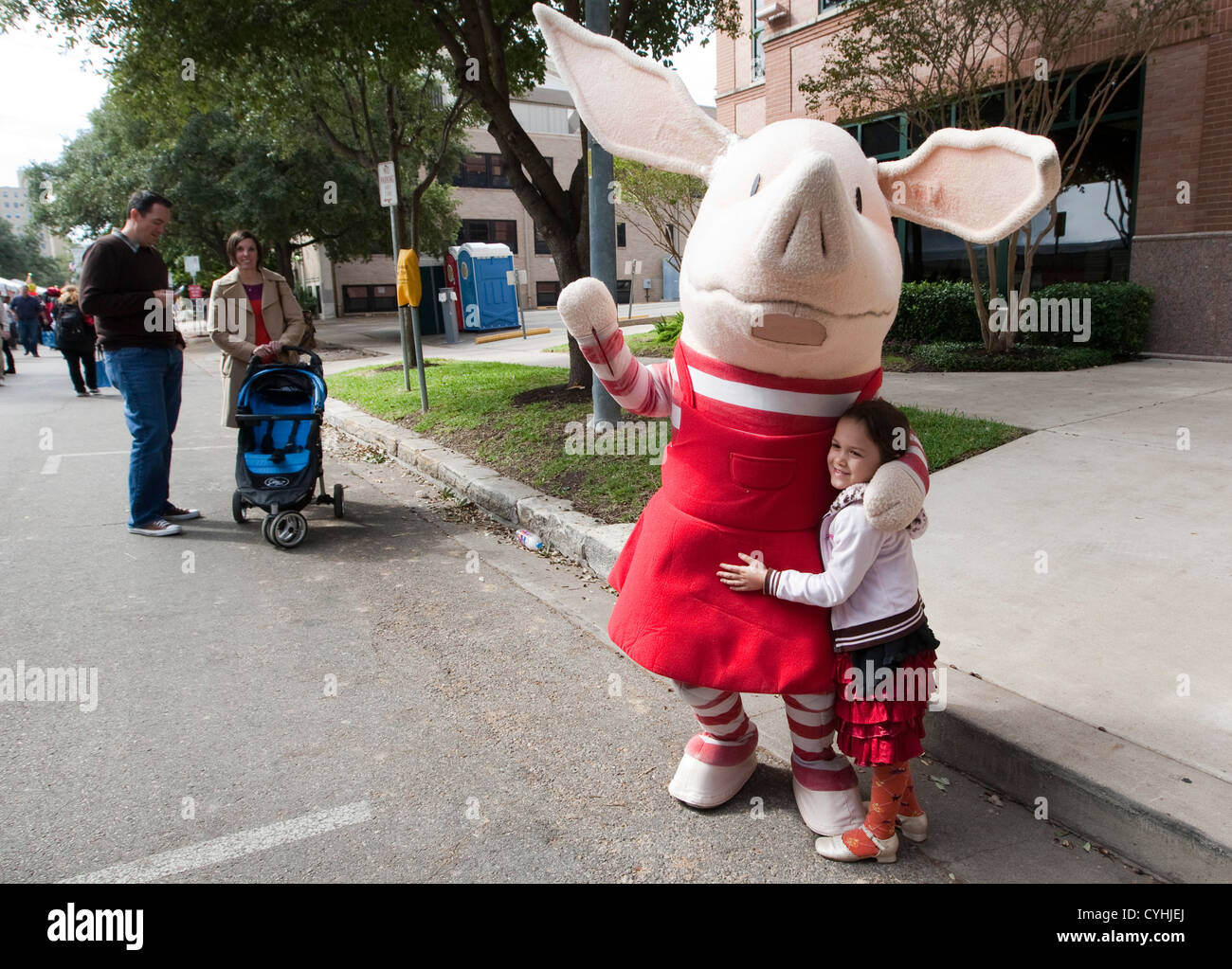 Actor in Olivia the Piglet costume greets young fan near the children's activity tent at the Texas Book Festival in Austin. Stock Photo