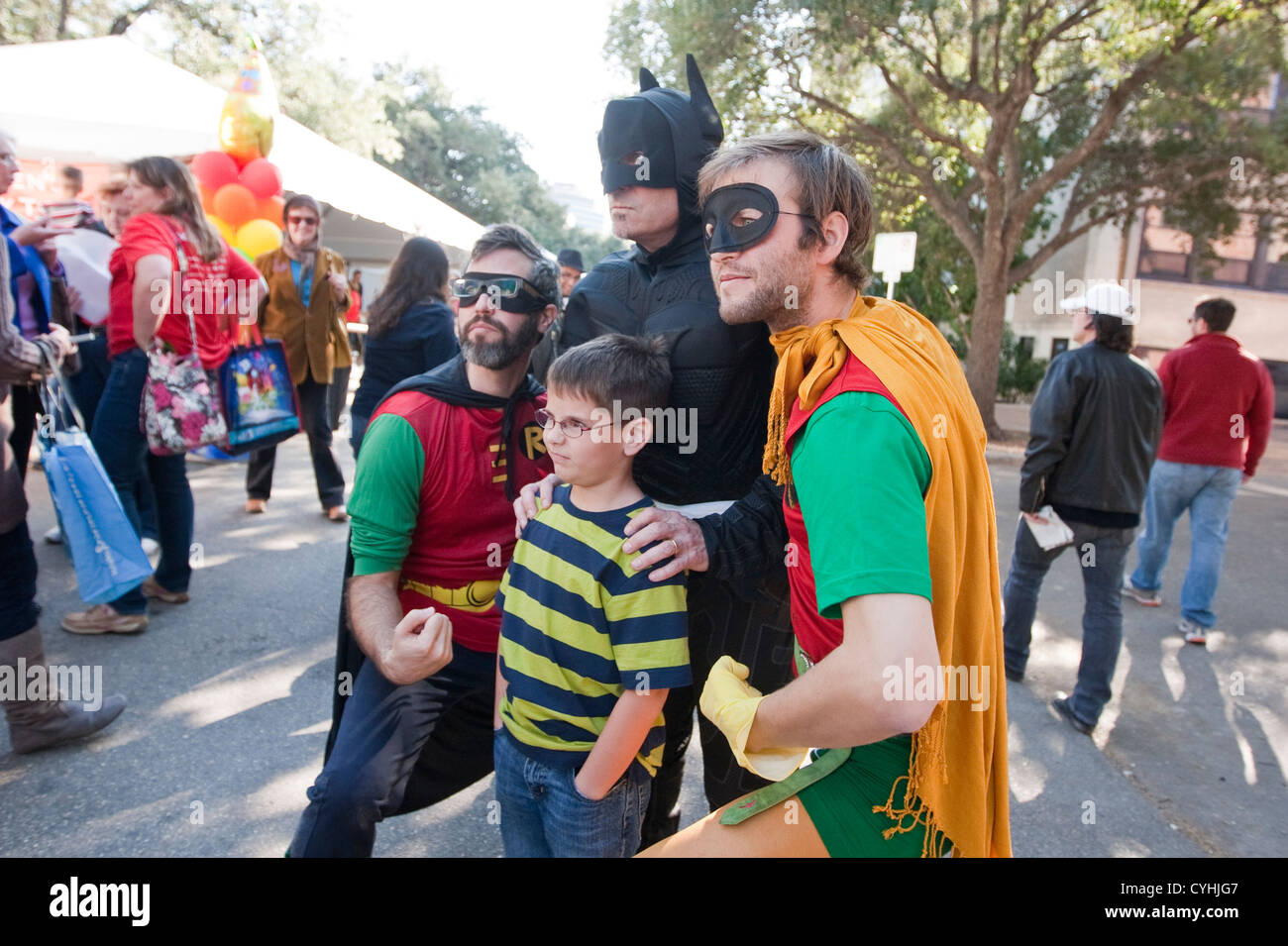 Children's authors dressed as Batman and Robins pose with fan outside children's activity tent at Texas Book Festival in Austin. Stock Photo