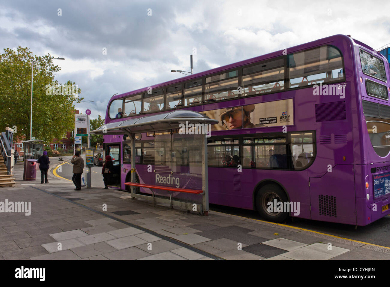 Passengers alight from a number 17 bus at a bus stop in the town of Reading in Berkshire. Stock Photo