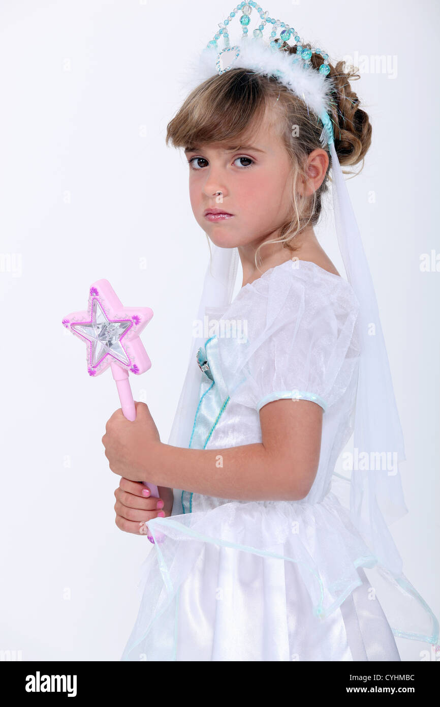 Little girl dressed as princess holding wand Stock Photo - Alamy