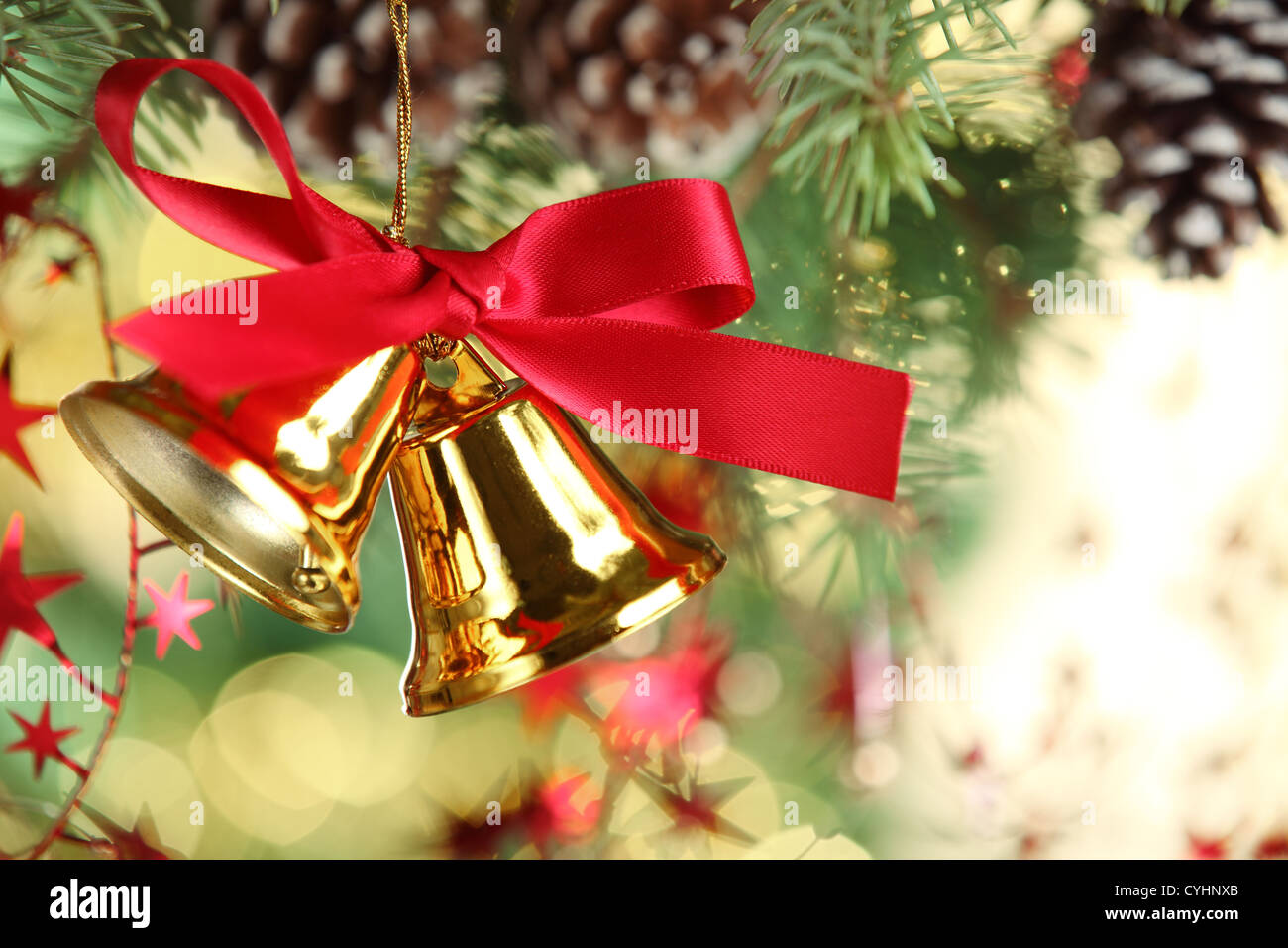 Jingle bell hanging from christmas tree Stock Photo