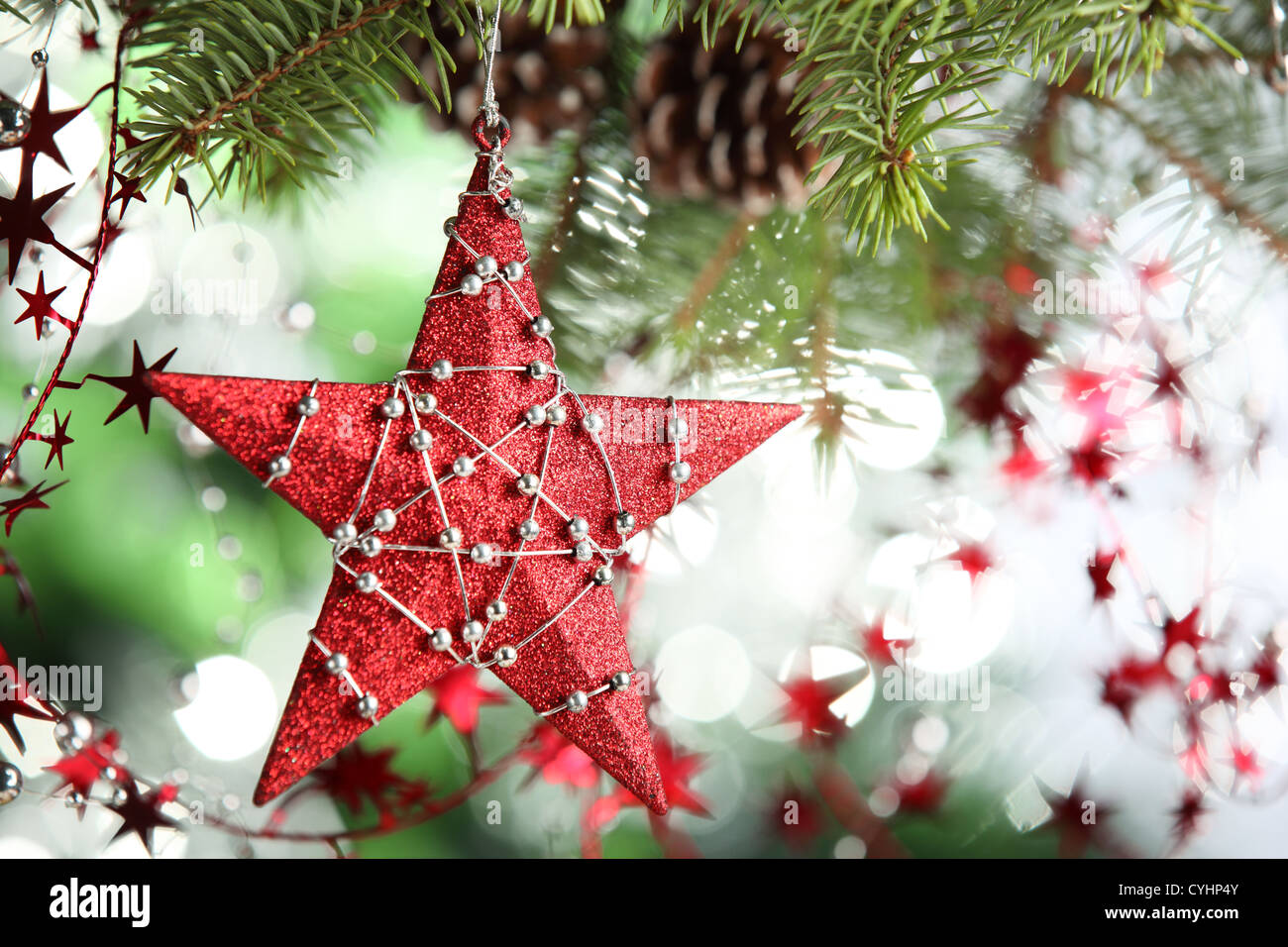 Red star hanging from christmas tree Stock Photo