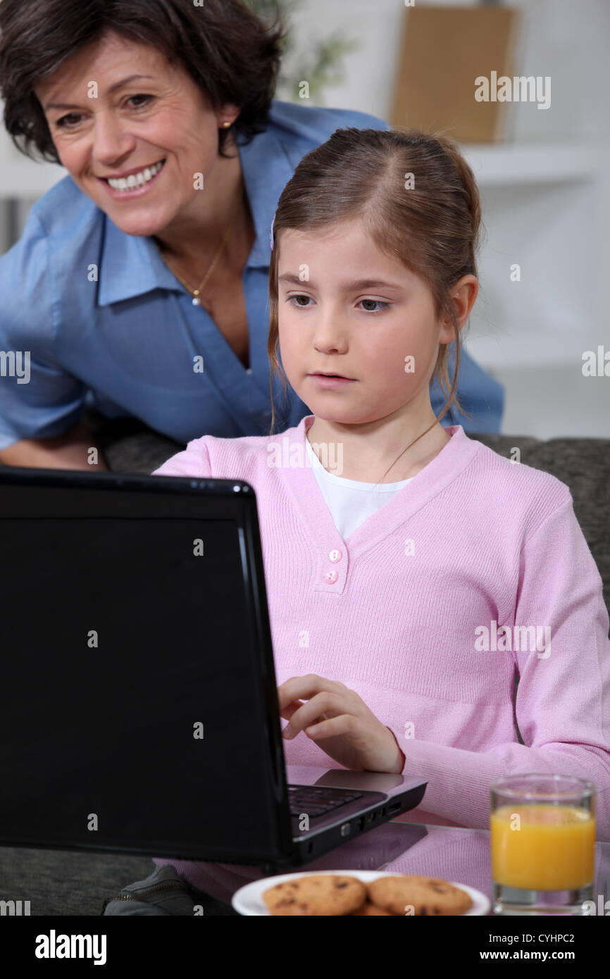 Little girl using laptop at home Stock Photo - Alamy