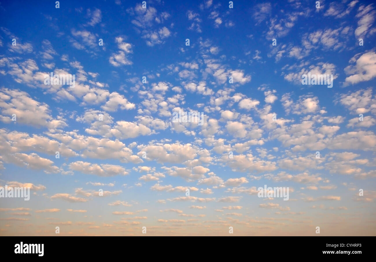 Blue sky with puffy white clouds Stock Photo - Alamy