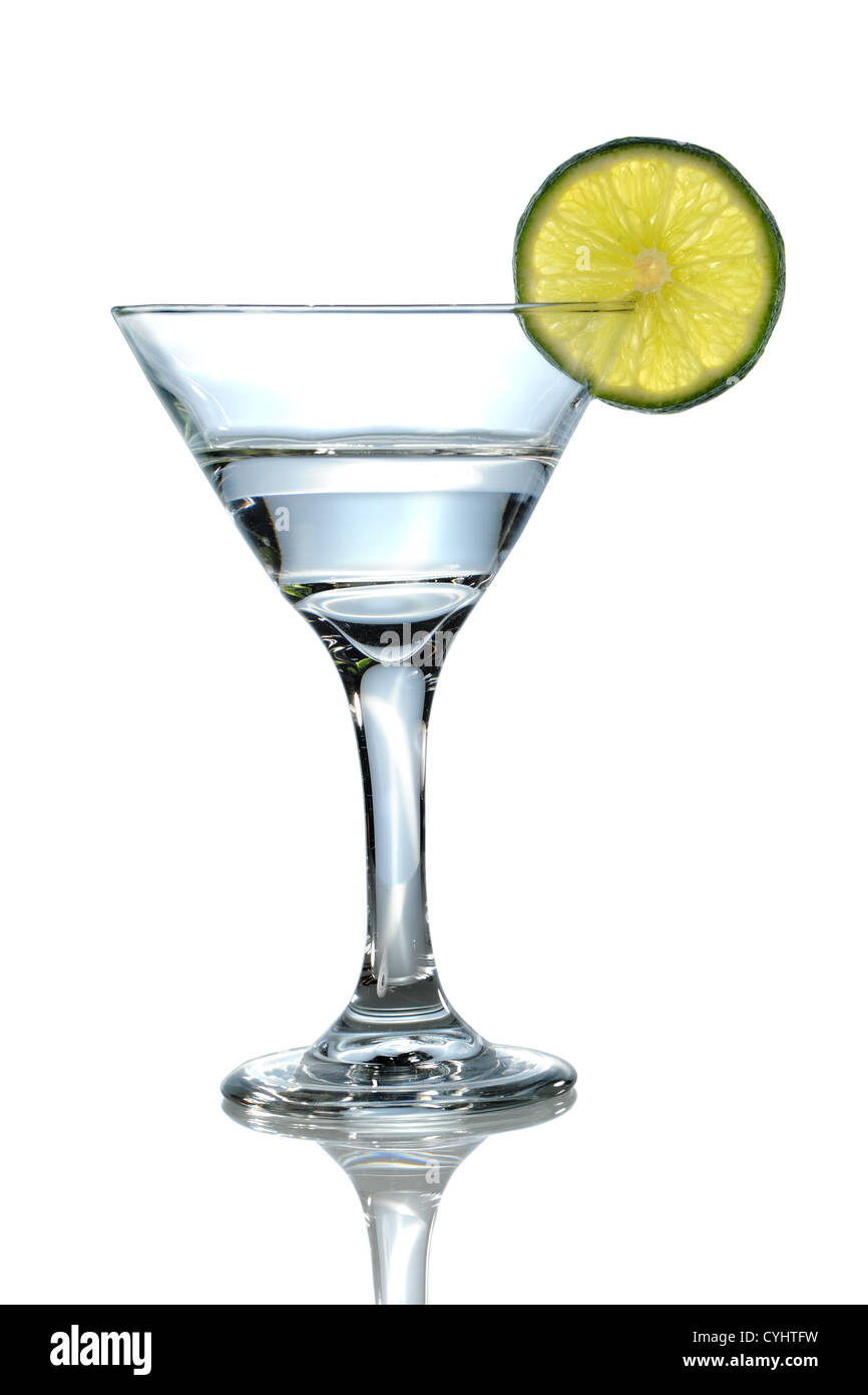 Martini glass with clear liquid and lime over white background - With Clipping Path Stock Photo