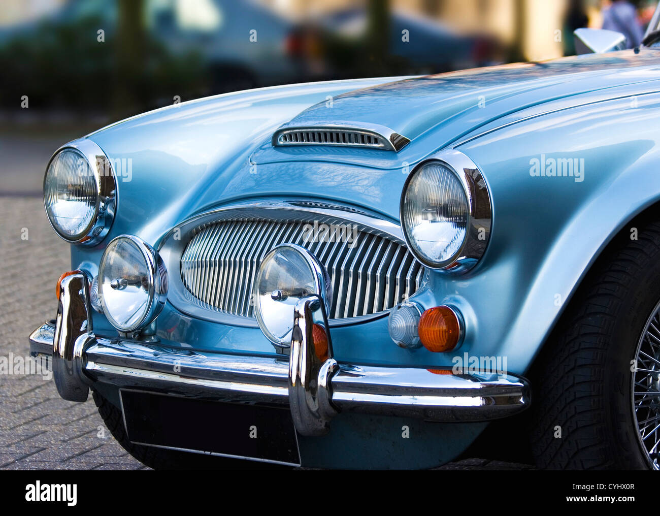A classic shiny metallic blue sports car on the streets Stock Photo